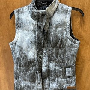 Multiple colors of gray vest lined in black. 100% polyester.